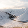 Snow covered Lindis Pass with winding road, Central Otago, New Zealand
